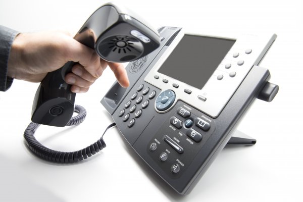 cost pricing axvoice voip service hand holding voip phone dialing making phone call 